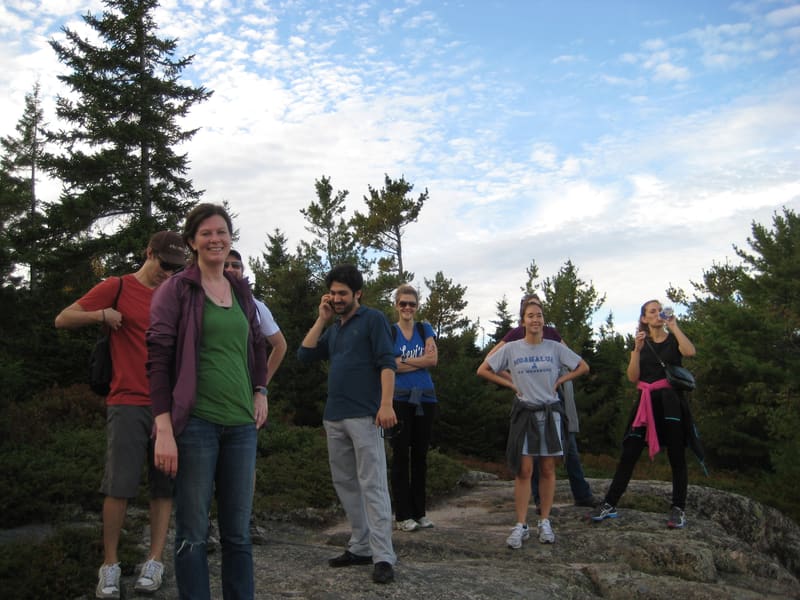Lab members taking in the view from a rocky summit