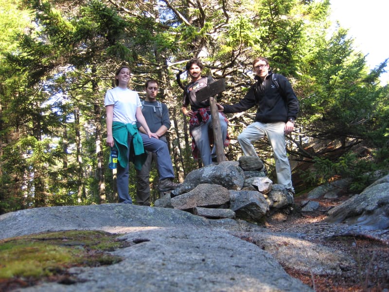 Lab members scrambling over rocks on an Acadia hike