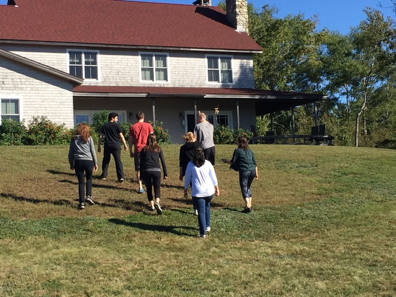 Lab members playing a lawn game outside the 2015 retreat house