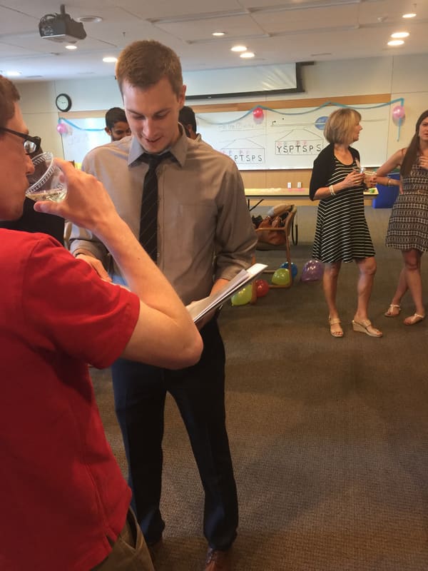 Kevin celebrating with guests after his thesis defense