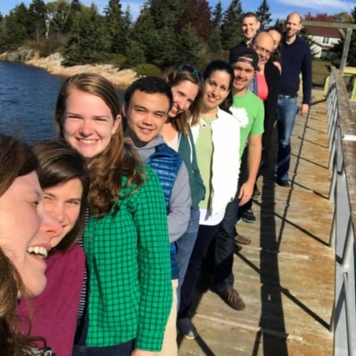 Churchman Lab members lined up together on a dock in West Tremont
