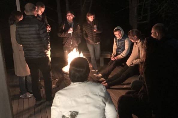 Lab members gathered around an evening fire