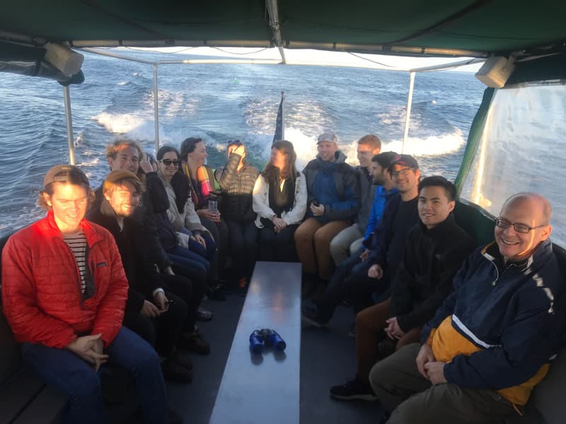 Churchman Lab gathered together on a boat