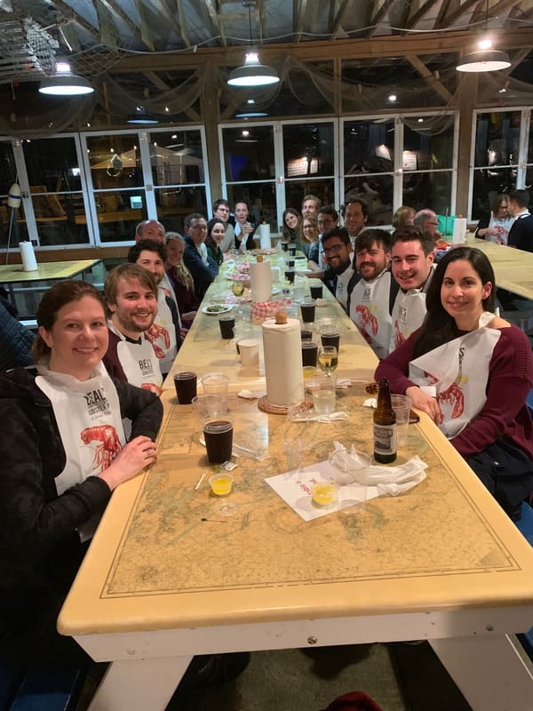 Lab members gathered around a long table during the retreat