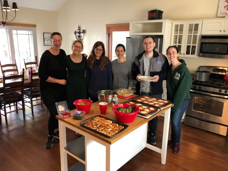 Four lab members preparing a shared retreat meal