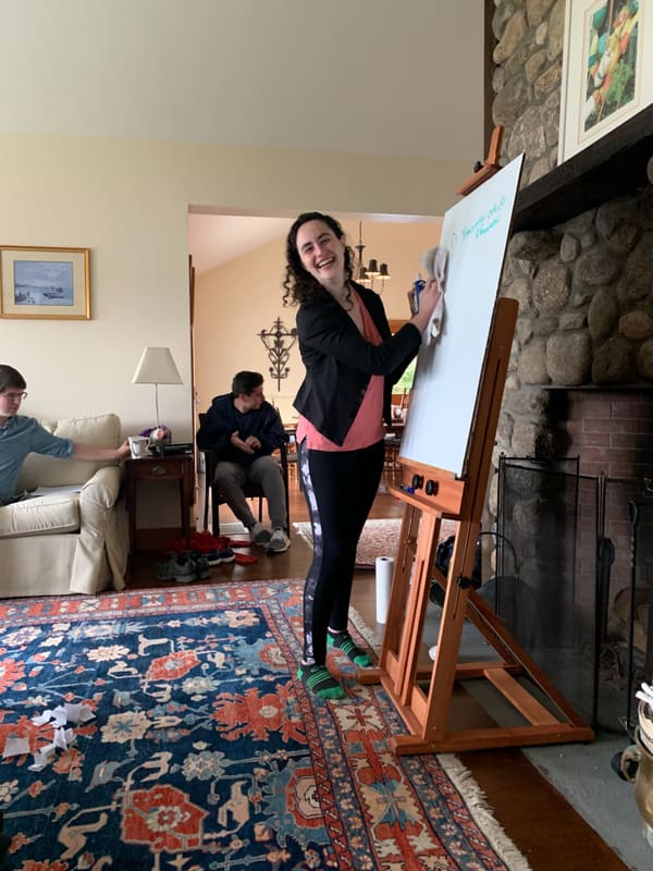 A lab member leading a chalk talk in the retreat house