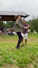 Two lab members dancing on the farmhouse lawn