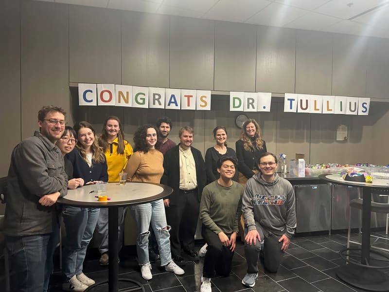 The Churchman Lab beneath a Congrats Dr. Tullius banner