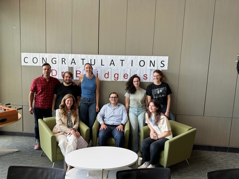 Jake and lab members posing together after his thesis defense