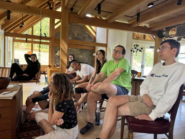 Lab members listening to a chalk talk in the farmhouse