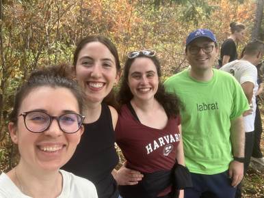 Four lab members smiling together during a hike