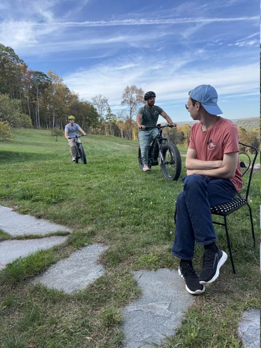 Lab members riding bikes on the hillside