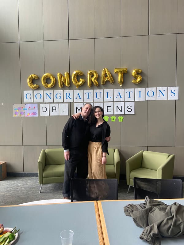Hope posing with family after her PhD defense