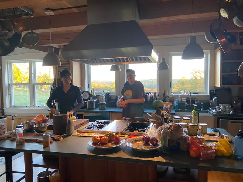 Lab members preparing food in the farmhouse kitchen